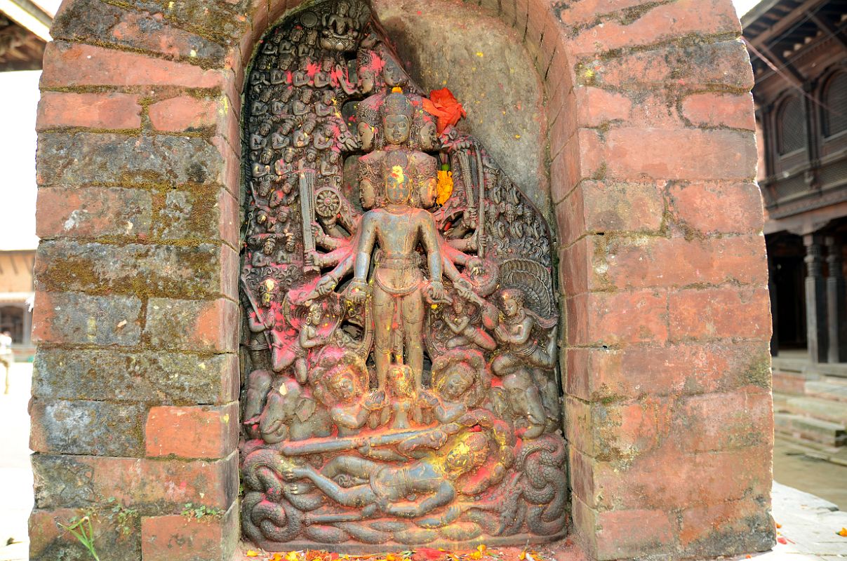 Kathmandu Changu Narayan 10-1 10 Headed And 10-Armed Vishnu Stone Statue With Another Vishnu Below Lying On Serpent Ananta A small black slab from 5C or 6C at Changu Narayan has a 10-headed and 10-armed standing Vishnu, with another Vishnu reclining on the serpent Ananta below. The scenes are divided into three sections  the heavens, the world of men, and the underworld below.